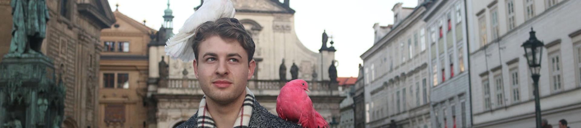 Student with birds sitting on them